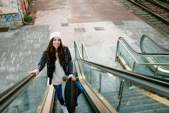 Beautiful skate woman on the scalator