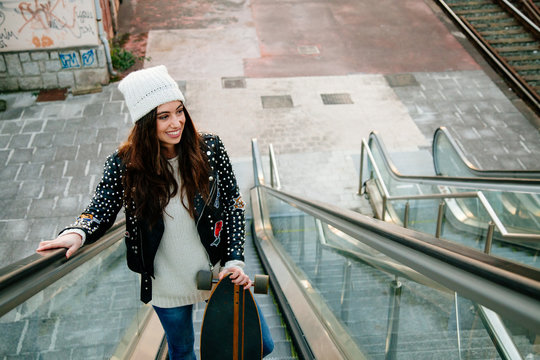 Beautiful skate woman on the scalator