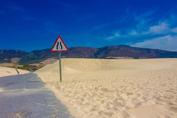 Road. White ocean sand, dunes. Punta Paloma beach, Tarifa, Spain.