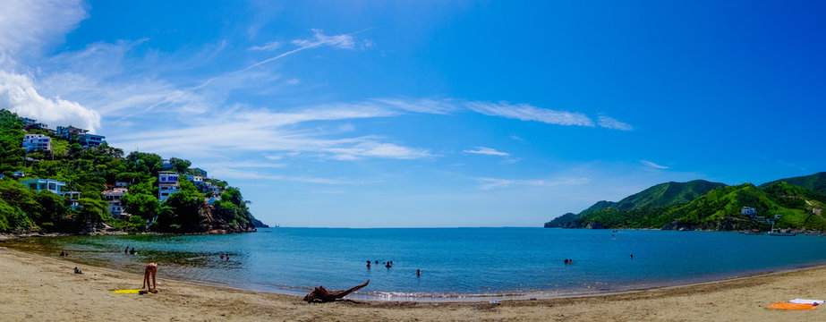 Beautiful panoramic view of Taganga, the caribbean coast with some tourists enjoying the sunny day in Colombia