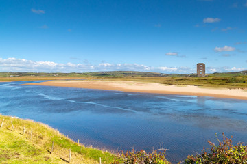 Fototapeta na wymiar River view with ruins of Dough Castle in Lahinch, Co. Clare, Ireland