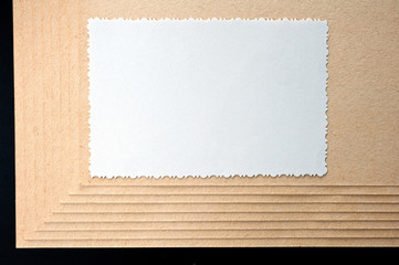 Sheet of paper and rough, textured cardboard
