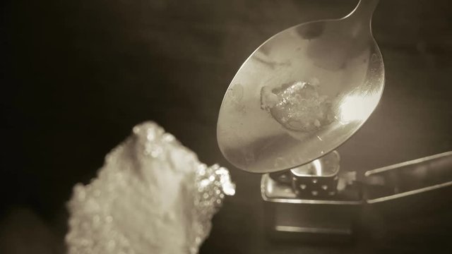 preparation of narcotic substance in the spoon on fire