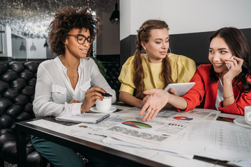 group of young businesswomen doing paperwork together