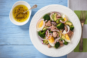 Healthy salad with tuna, eggs and broccoli.