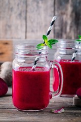 healthy detox beet smoothie with chia seeds in a mason jar on a wooden background