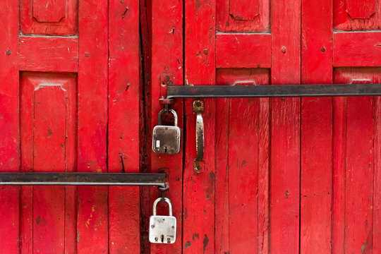 two locks on an old red wooden door