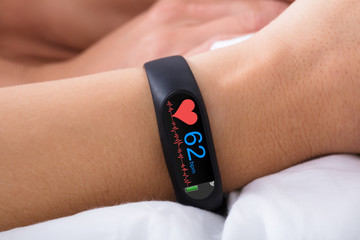 Fitness Activity Tracker With Heartbeat Rate On Woman's Hand