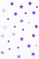 Holiday background with violet star confetti. Good background for Christmas and New Year cards.