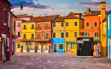 Bright coloured houses on Burano island Venice Italy with blue - obrazy, fototapety, plakaty
