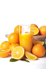 Fototapeta na wymiar glass of orange juice with fruit and press citrus on white background