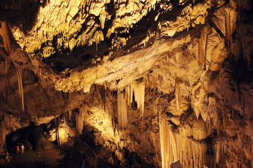 Wonderful columns of stalactites looking like water falls inside the cave of Antiparos, an amazing cave renowned for its rich stalactite and stalagmite decorations. Antiparos, Cyclades, Greece.