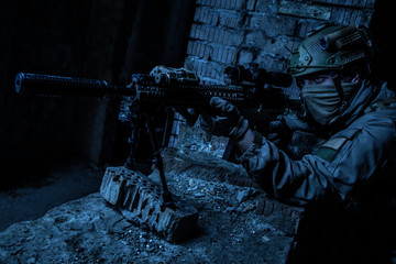 Marksman in action in the ruined city under cover of darkness