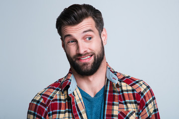 Obraz premium Really? Portrait of handsome young man looking sarcastic while standing against white background