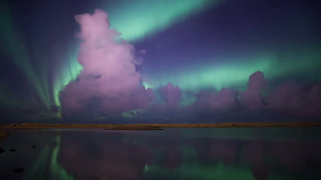Bright green aurora purple clouds reflecting calm water lake fantasy landscape Iceland 4k.mov