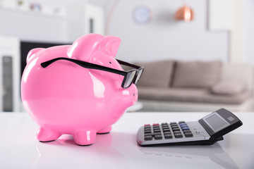 Close-up Of Pink Piggybank Wearing Spectacles