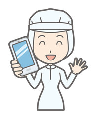 A female worker wearing white sanitary clothing has a smartphone