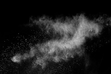 Freeze motion of white powder explosions isolated on black background.