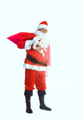 Real Santa Claus carrying big bag full of gifts, isolated on white background
