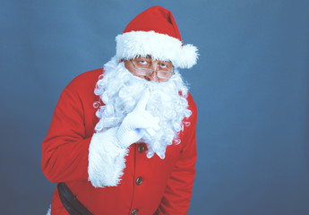 Real Santa Claus carrying big bag full of gifts, isolated on white background