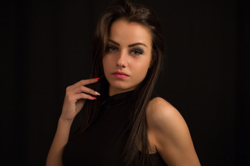 Fototapeta premium Fashion close up portrait of young sexy beautiful brunette woman with professional makeup.Long hiair and smoky eyes,perfect skin.Hot Girl looking at camera
