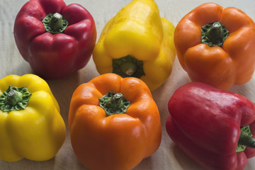 Red, Yellow & Orange Peppers on Cutting Board