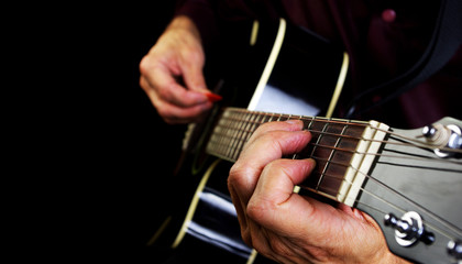Obraz na płótnie Canvas Playing an Acoustic Guitar. Closeup.