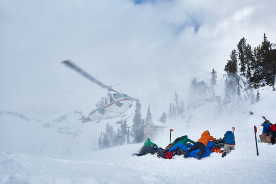 Helicopter Landing On A Snowy Mountain