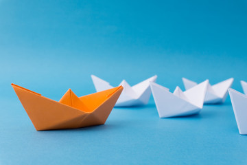 Business Leadership Concept - Yellow Color Paper ship Origami leading the rest of the white paper...