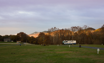 View from a campground of sun seting over mountains