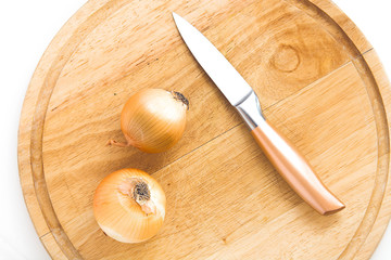 Pair of onions alongside with knife on the cutting table © nimless