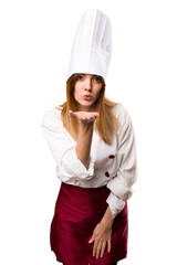 Beautiful chef woman sending a kiss