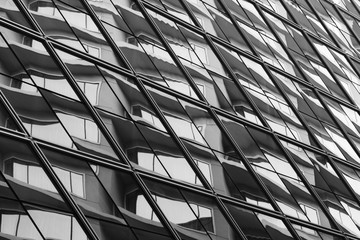 pattern of glass window with reflection at modern building - monochrome