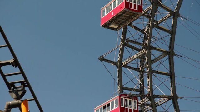 Rotation movement of the giant white Blumenrad ferris wheel in Vienna capital of Austria on clear blue sky background in the Prater park tourist attraction Europe travel