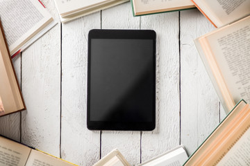 Black Ebook Reader with Many Paper Books