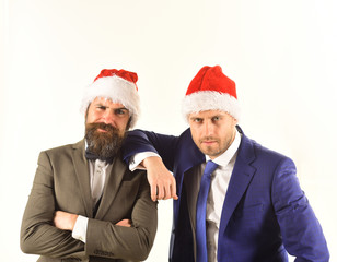 Businessmen with confident smiles lean on each other.