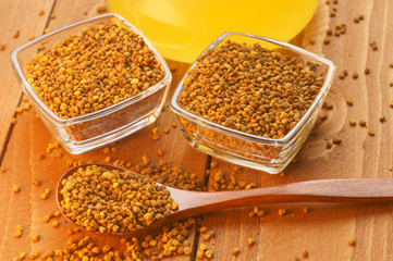 Top view of bee pollen, spoon, honey