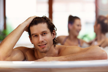 Group of friends enjoying jacuzzi in hotel spa