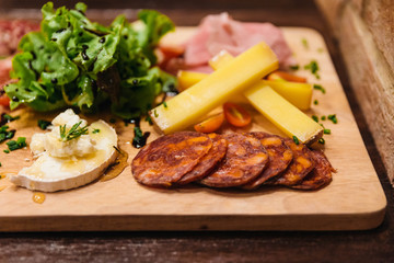 Cold cuts: Salami, Chorizo, Pepperoni and meats served with cheese, vegetable salad, red wine and cut toasts with mince scallion, rosemary balsamic dressing.