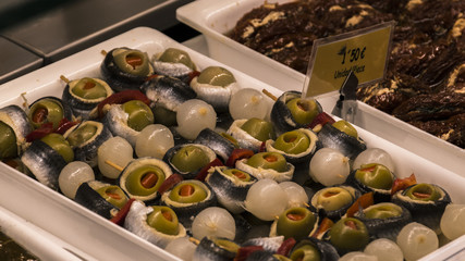 Tapas of olives, peppers, anchovies in vinegar and onions. Typical Spanish tapas