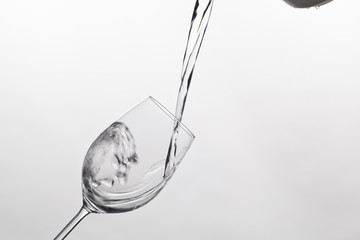 water is poured into a glass of water