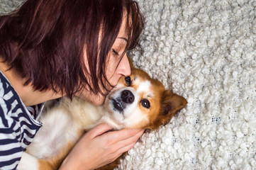 the young woman kisses the dog
