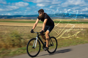 Fototapeta na wymiar Young cyclist in with meadow background