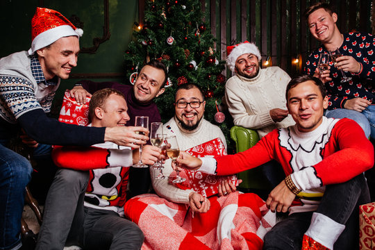 Friends celebrating Christmas with champagne glasses and make a wish