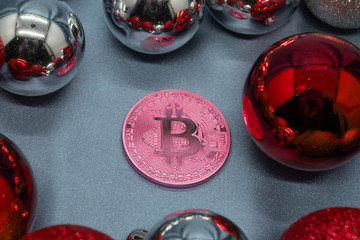 Happy New year Bitcoin bauble with gold ribbon on a wooden background.