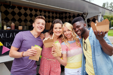 happy friends with wok and burger at food truck