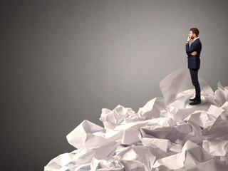 Businessman standing on crumpled paper