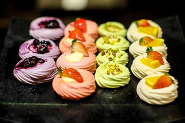 small sweet cream with fruit(strawberry, blueberry, orange) and nut on the top