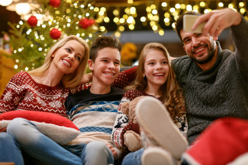 Obraz na płótnie Canvas Family on Christmas holiday making selfie together