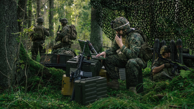 Military Staging Area, Chief Engineer Uses Radio And Army Grade Laptop. Forest Operation/ Mission In Progress.